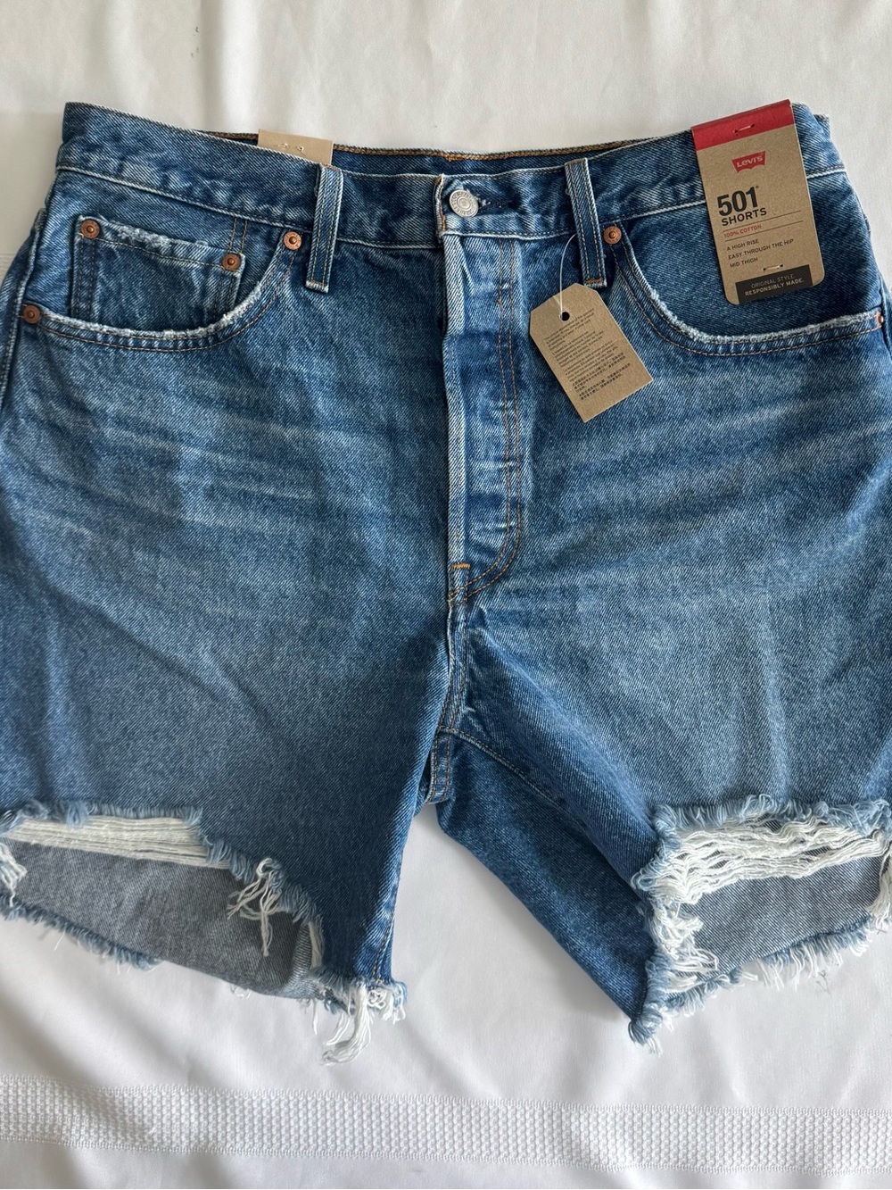 Levi's distressed blue denim jeans with back pocket detail